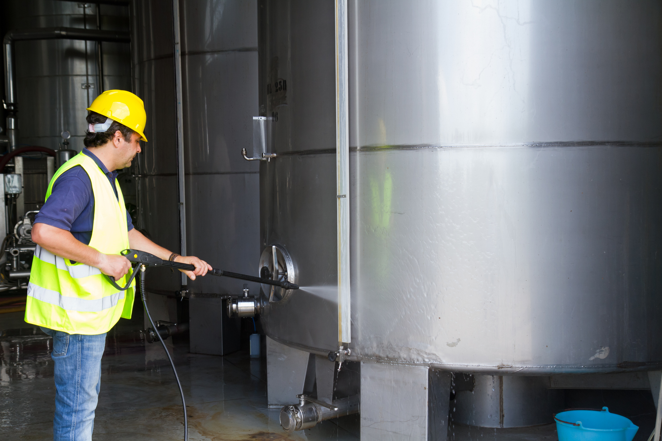 man washing around the industrial site